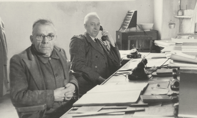 861072 Portret van de heren Reijneveld (links, chauffeur) en Zwagers (bedrijfsleider) op het kantoor van Maatschappij ...